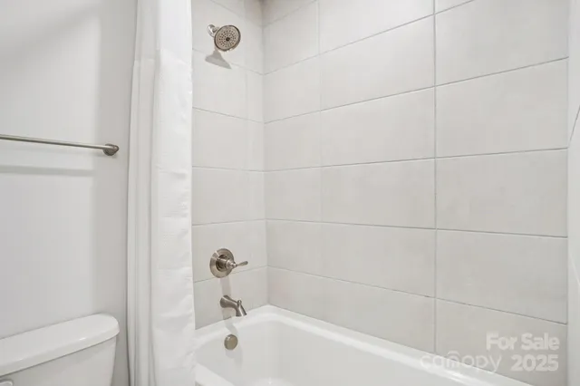 a bathroom with a bathtub and a toilet