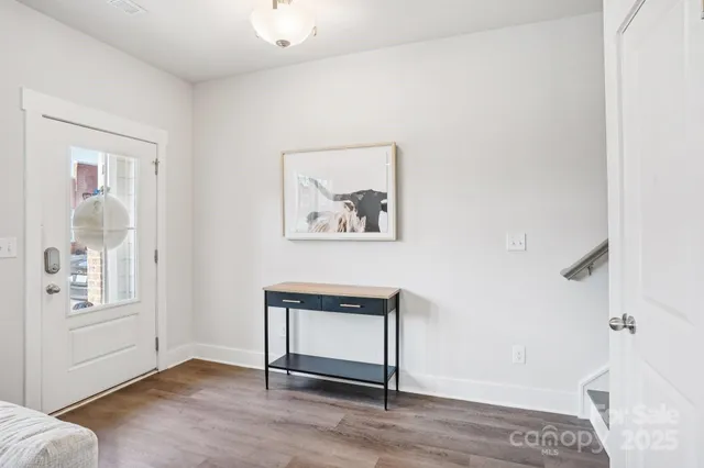 a view of a livingroom with wooden floor and a window