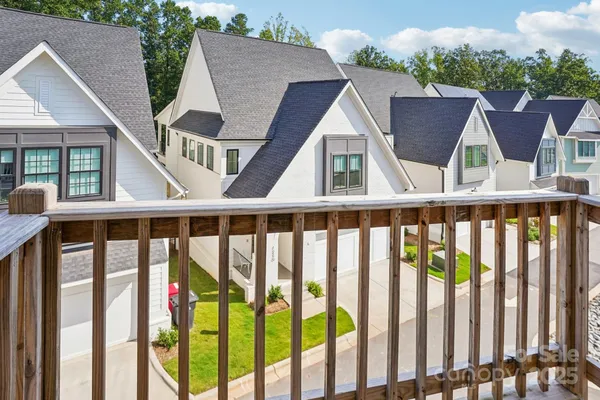 a view of balcony with wooden floor and fence