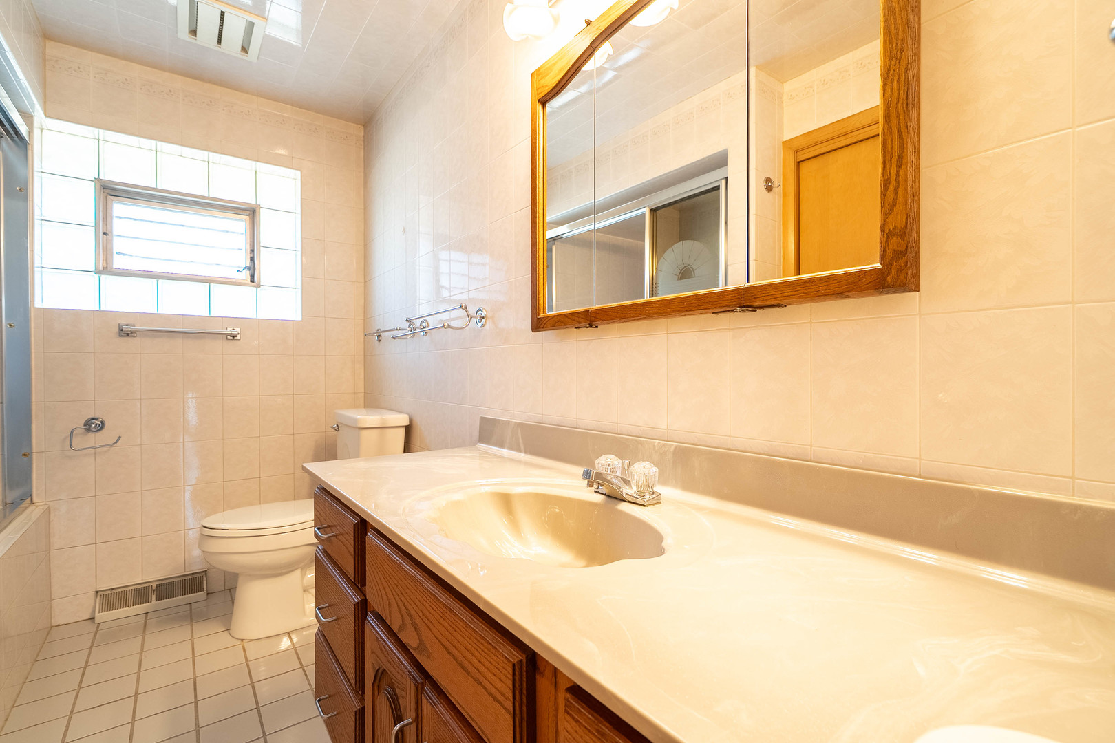 17258 William Street Lansing, IL 60438 - Photo 13 of 34 a bathroom with a sink and a toilet