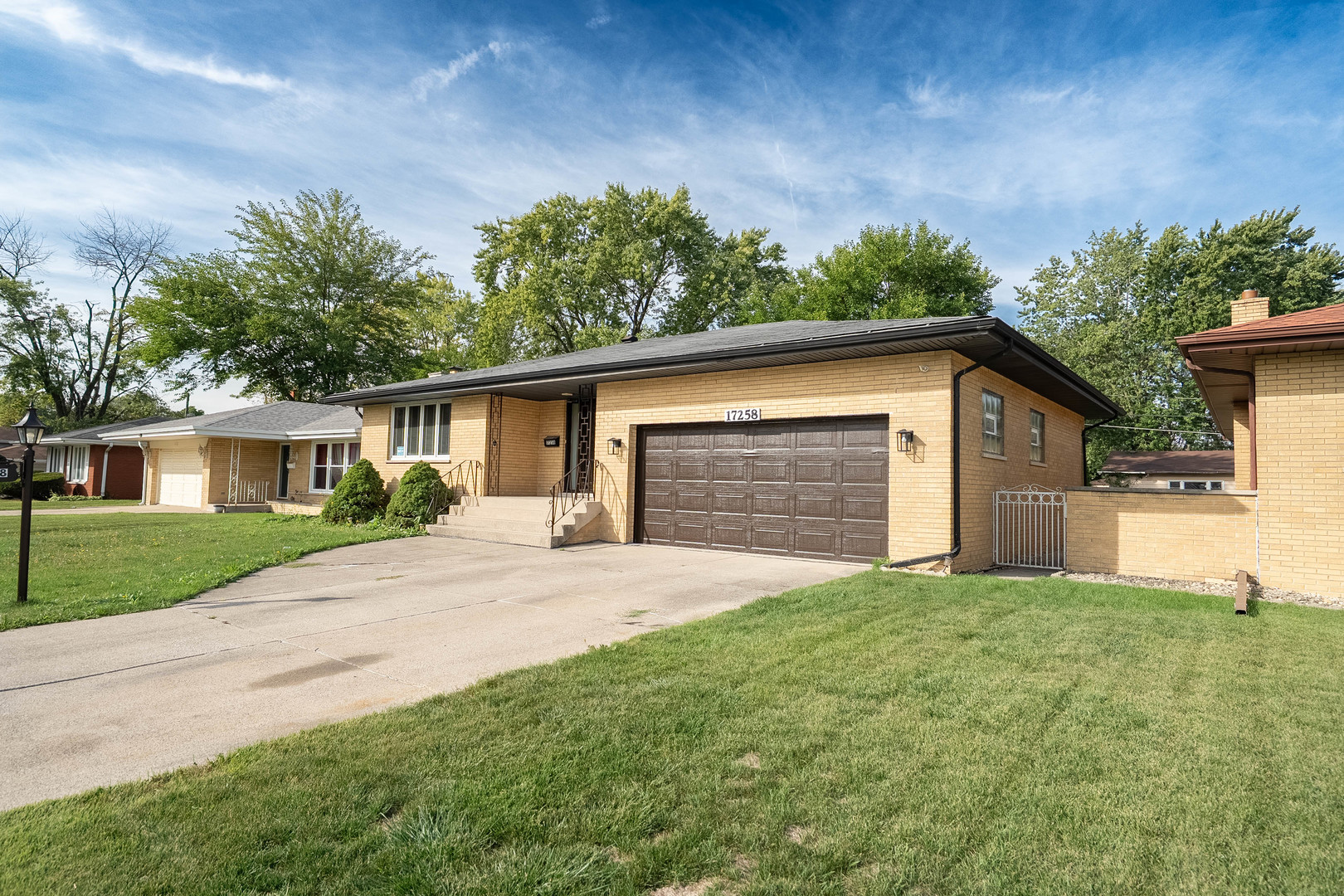 17258 William Street Lansing, IL 60438 - Photo 2 of 34 a front view of a house with a yard and garage