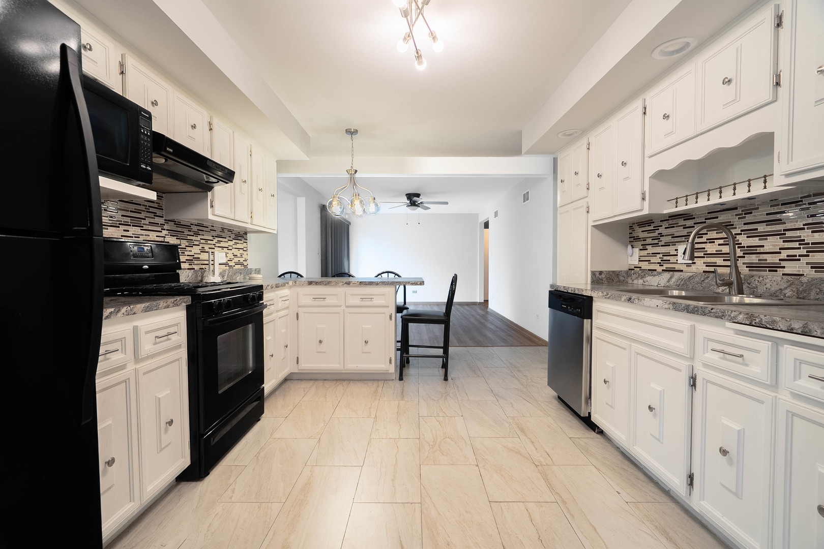 17258 William Street Lansing, IL 60438 - Photo 3 of 34 a kitchen with stainless steel appliances kitchen island granite countertop a stove and a sink