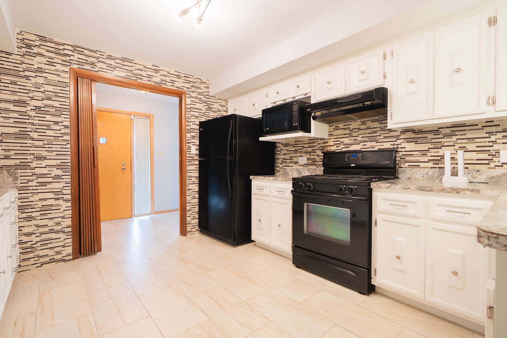 17258 William Street Lansing, IL 60438 - Photo 4 of 34 a kitchen with stainless steel appliances granite countertop a refrigerator stove and sink