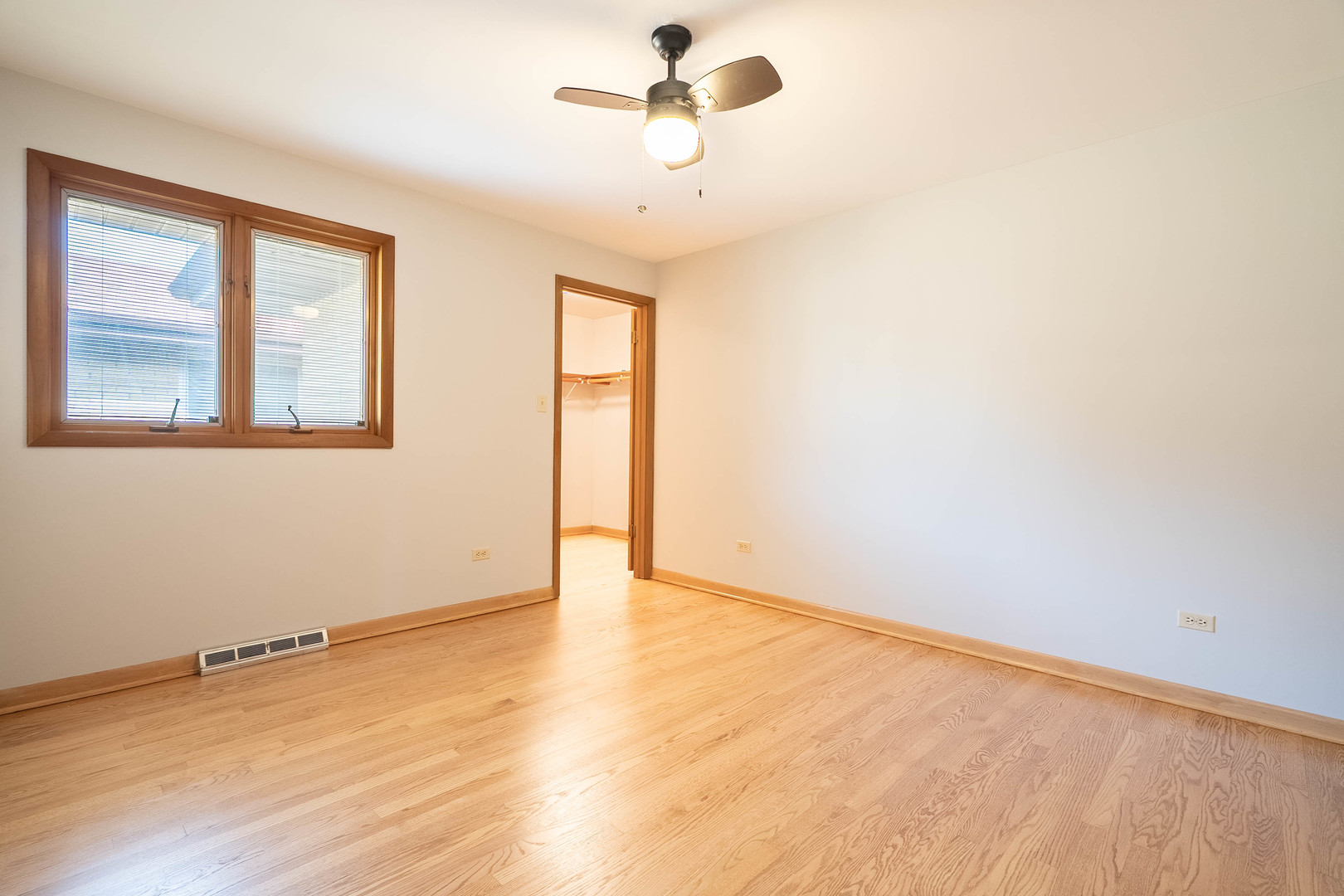 17258 William Street Lansing, IL 60438 - Photo 9 of 34 a view of an empty room with wooden floor and a window
