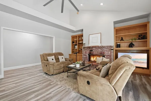 a view of a workspace with furniture and wooden floor
