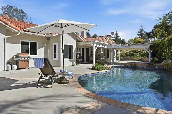 a front view of a house with plants