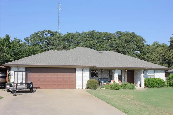 a front view of a house with a garden and plants