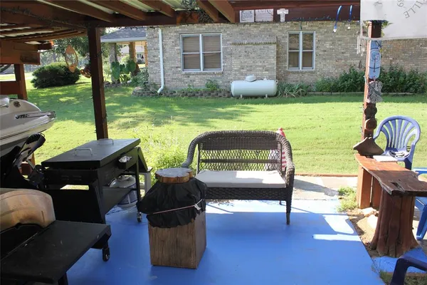 a view of a house with backyard porch and sitting area