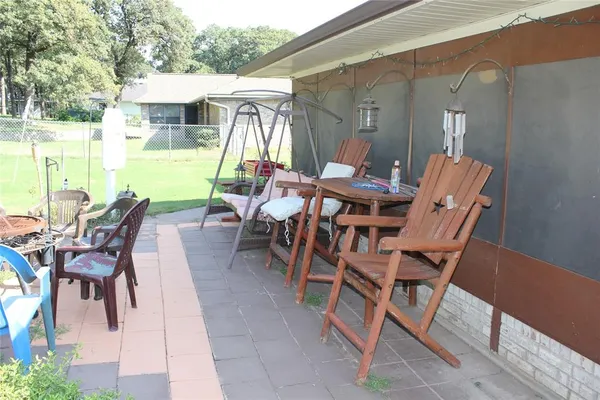 a view of a patio with table and chairs and potted plants