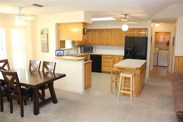 a kitchen that has a table and chairs in it