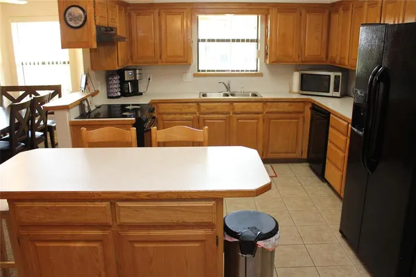 a kitchen with stainless steel appliances granite countertop a sink a stove and a microwave