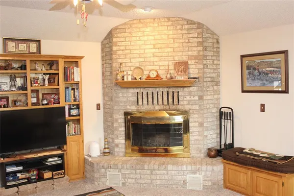 a living room with fireplace furniture and a flat screen tv