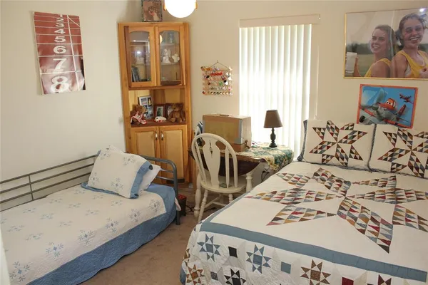 a bedroom with bed and glass door