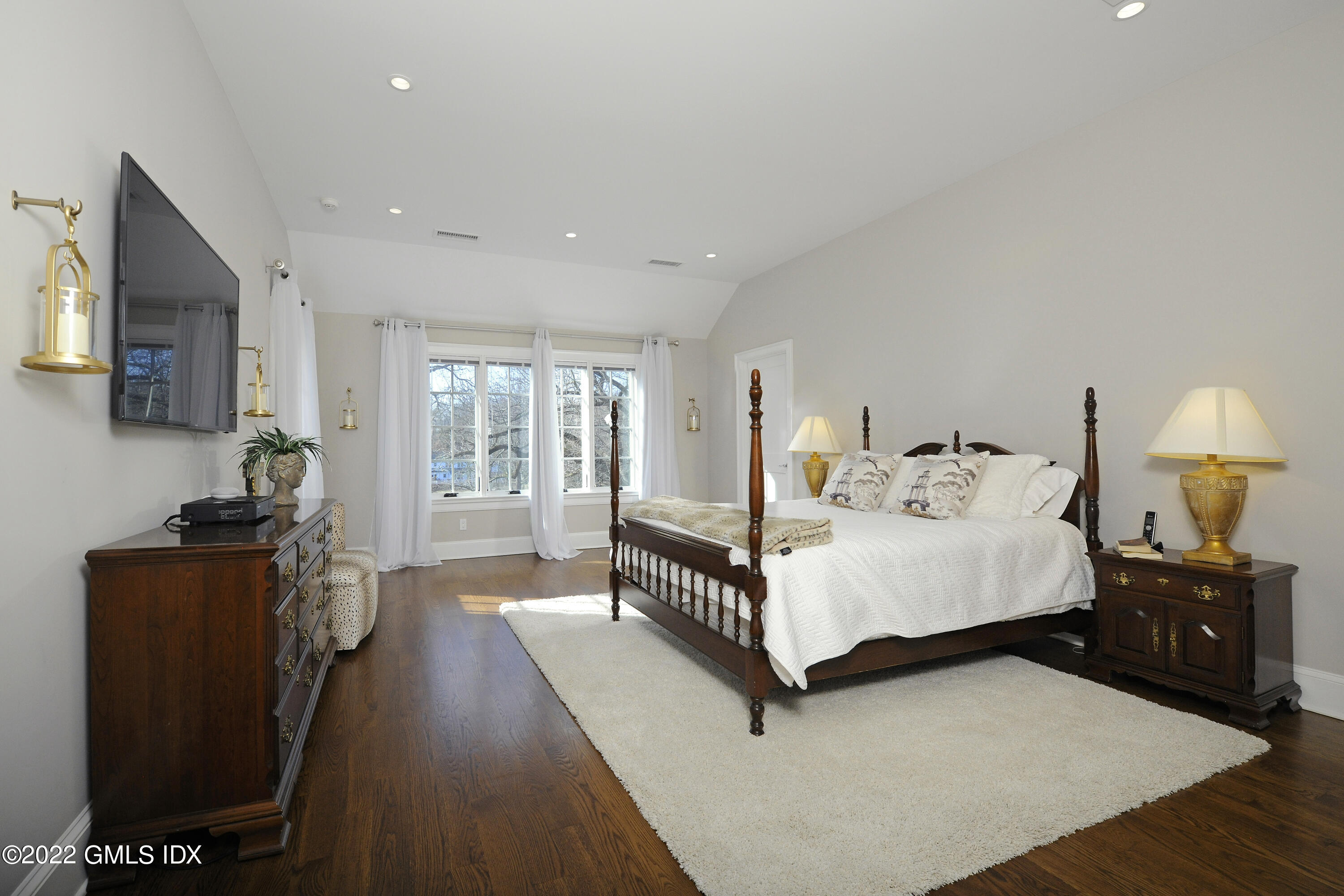 113 Woodside Drive Greenwich, CT 06830 - Photo 17 of 37 a spacious bedroom with a bed a couch and dresser