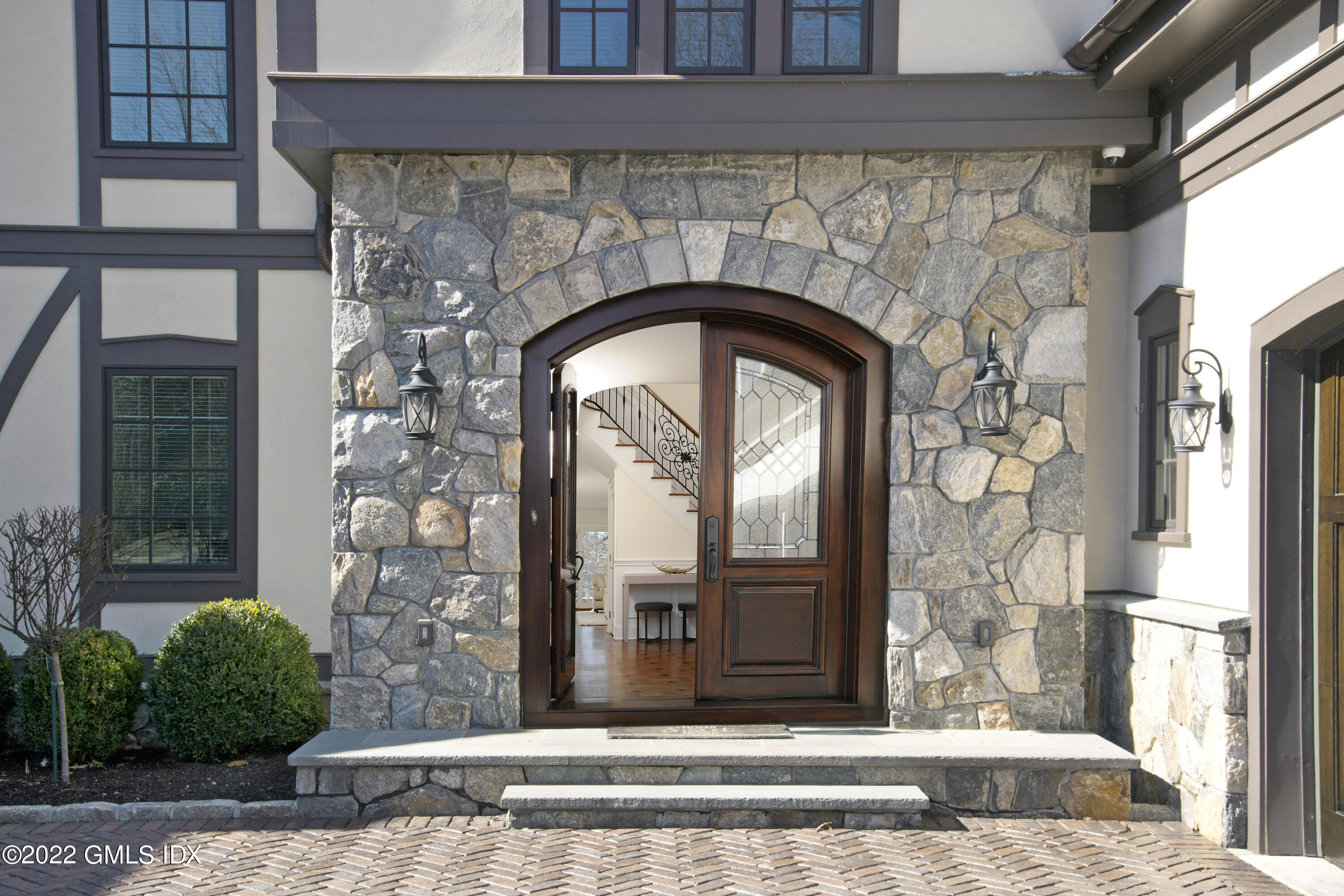 113 Woodside Drive Greenwich, CT 06830 - Photo 2 of 37 a front view of a house with garden