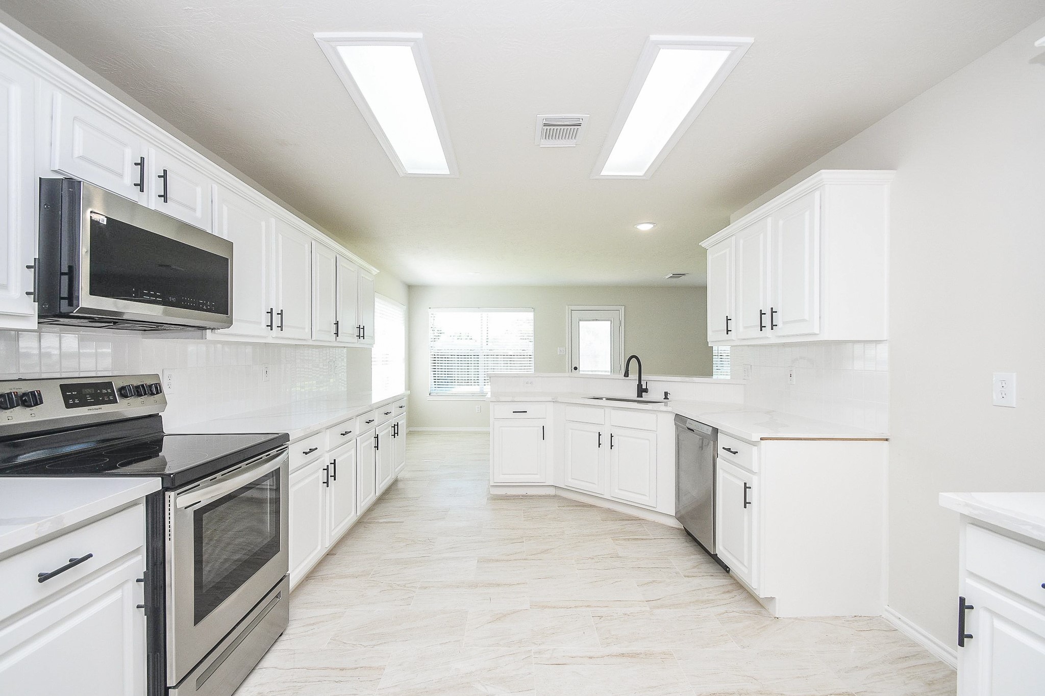 4810 Arbor Court Rosenberg, TX 77471 - Photo 5 of 20 a large kitchen with cabinets and stainless steel appliances