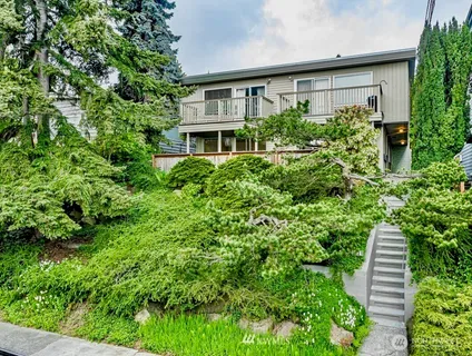 a view of a house with potted plants