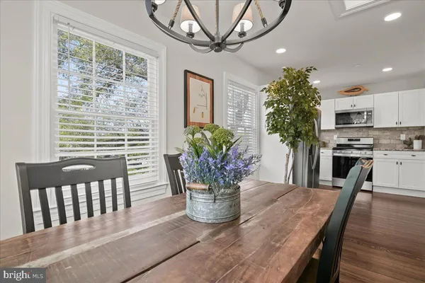 a kitchen with stainless steel appliances granite countertop a stove a microwave and a sink