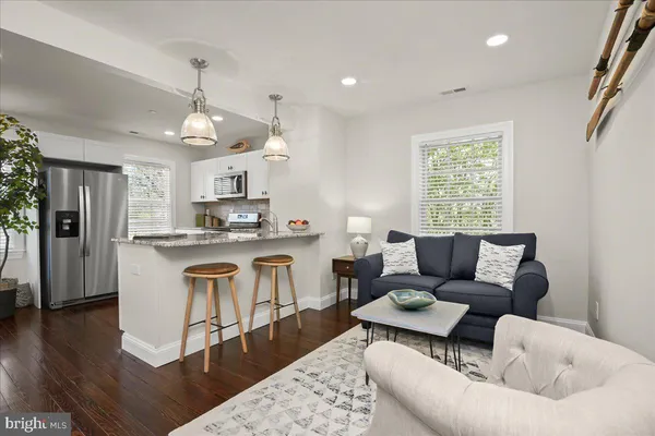a bedroom with a bed and a potted plant on the dresser