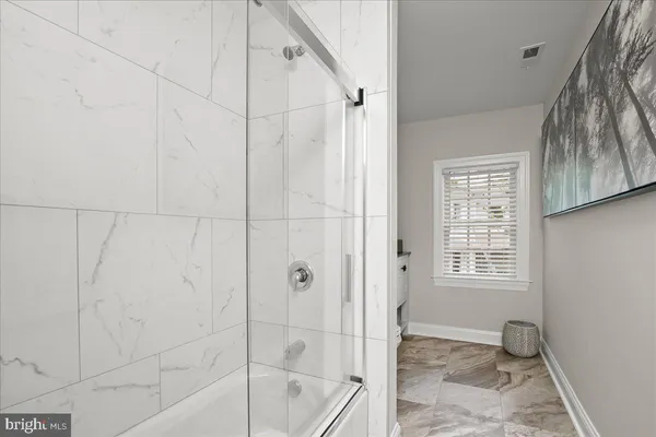 a bathroom with a sink a toilet and a shower