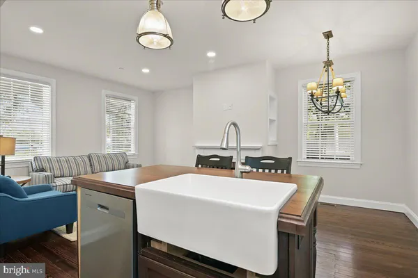 a bathroom with a toilet sink vanity and mirror