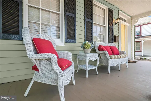 a view of a dining room with furniture a chandelier and wooden floor
