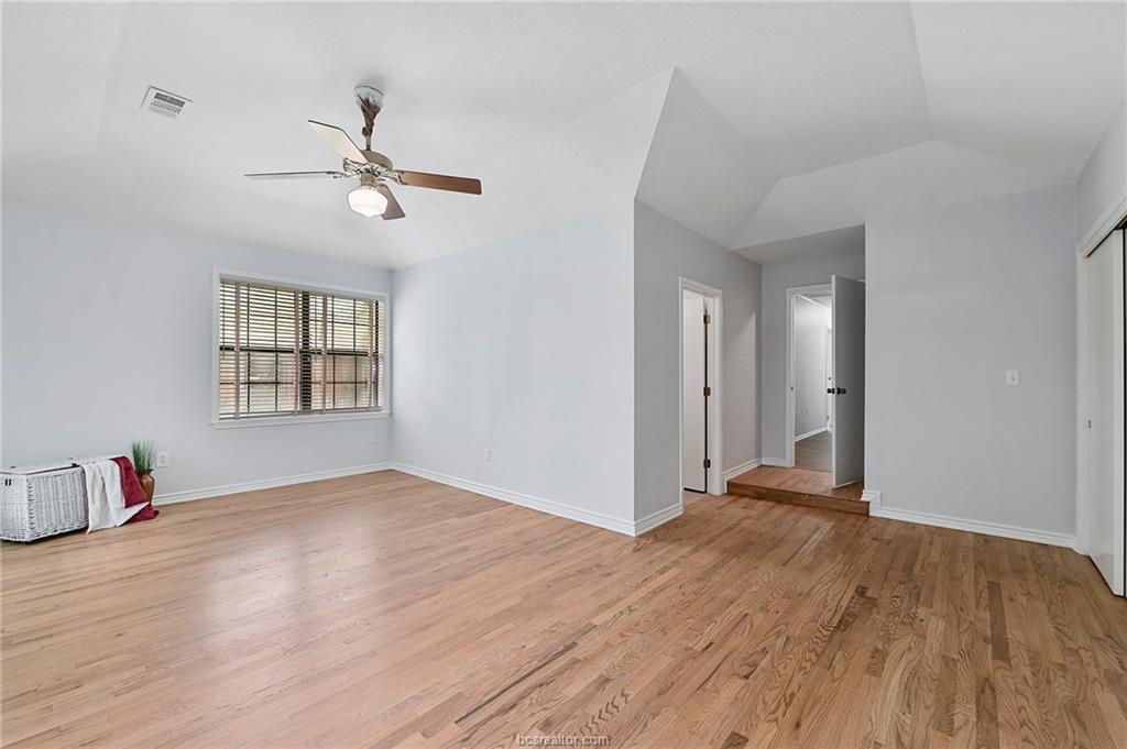 1031 Rose Circle College Station, TX 77840 - Photo 15 of 26 Spare room featuring light wood finished floors, ceiling fan, and lofted ceiling