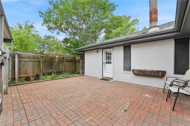 a backyard of a house with table and chairs