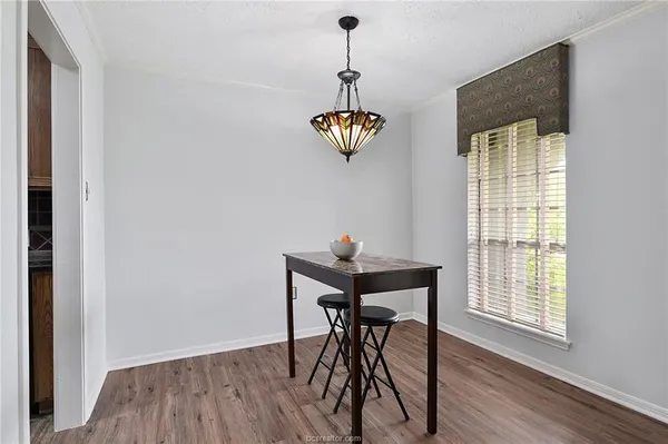 a view of a dining room with furniture wooden floor and chandelier