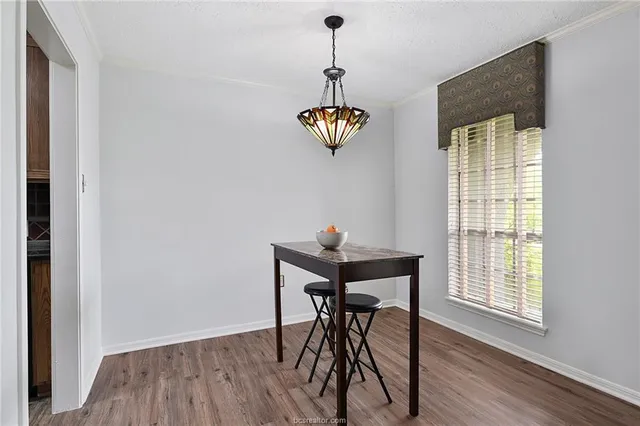 a view of a dining room with furniture wooden floor and chandelier