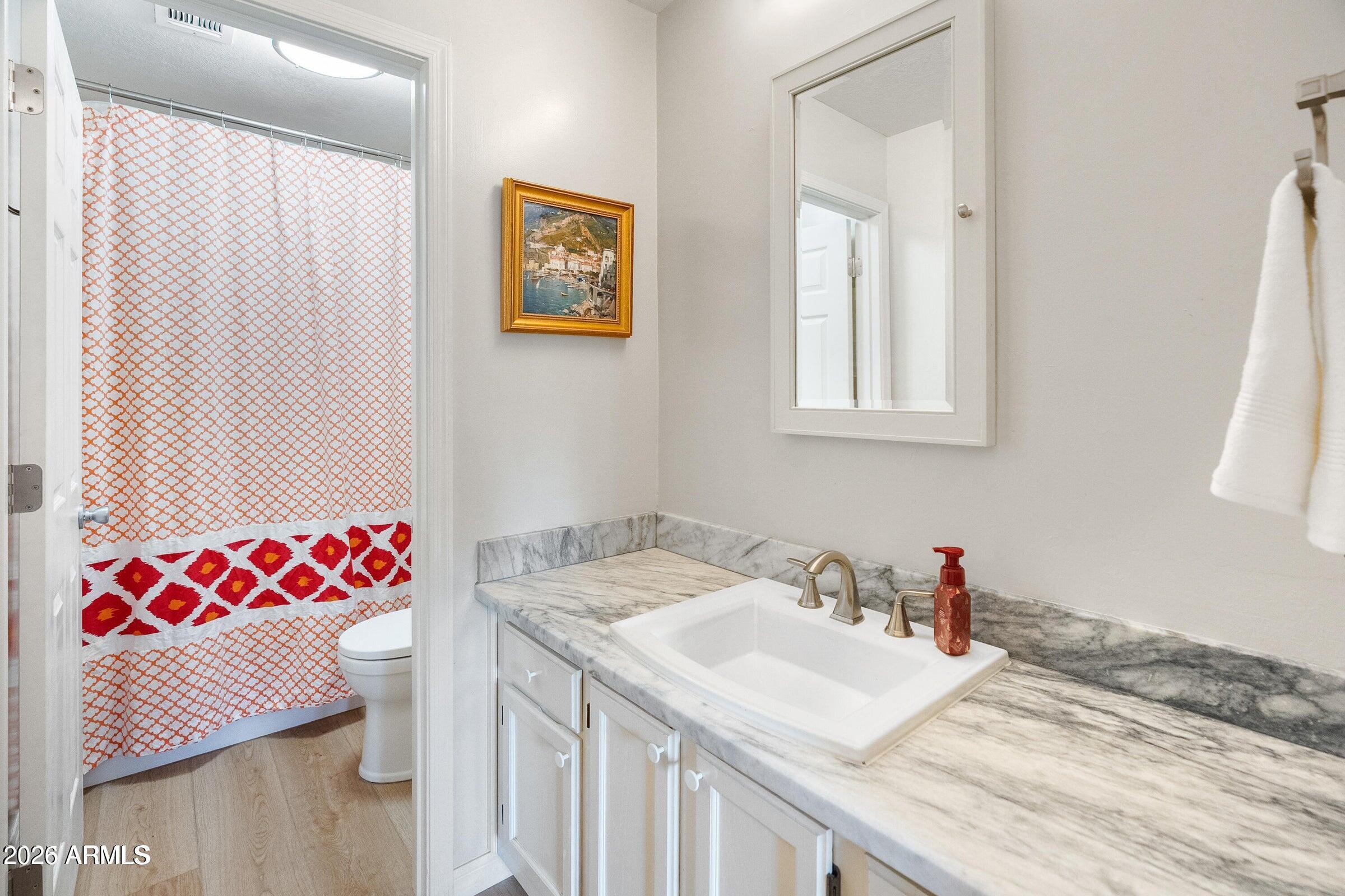 6885 East Cochise Road, Unit 132 Paradise Valley, AZ 85253 - Photo 5 of 10 a bathroom with a sink and a mirror