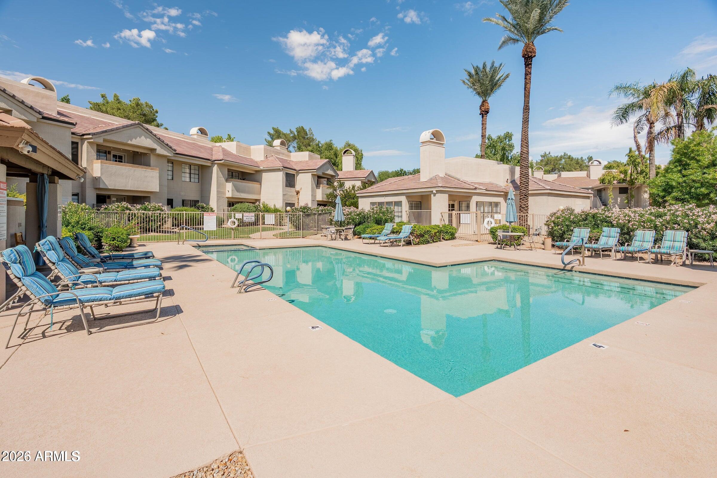 6885 East Cochise Road, Unit 132 Paradise Valley, AZ 85253 - Photo 8 of 10 a swimming pool with outdoor seating and yard