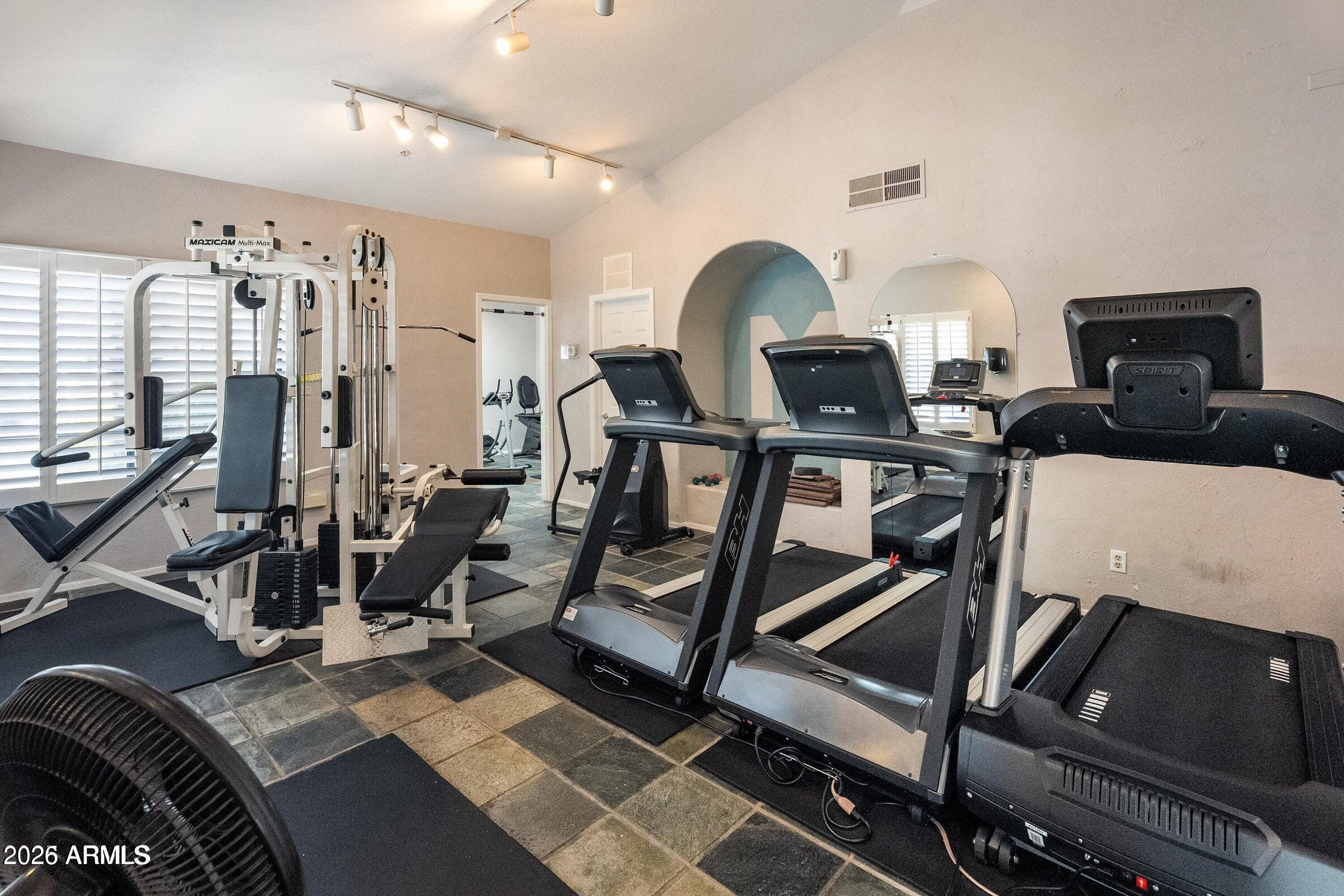 6885 East Cochise Road, Unit 132 Paradise Valley, AZ 85253 - Photo 9 of 10 a living room with furniture a flat screen tv and a fireplace