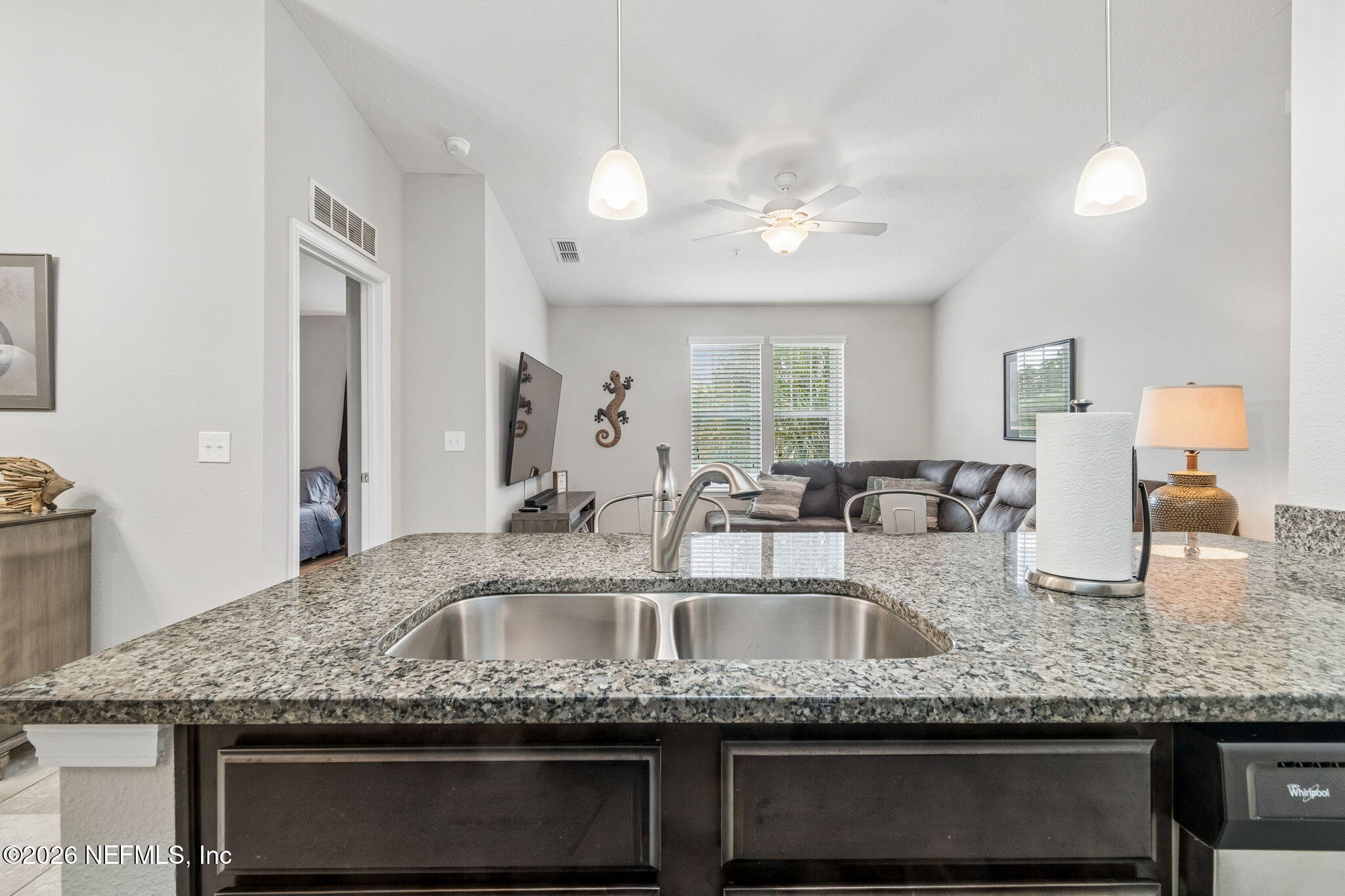 2113 Golden Lake Loop St. Augustine, FL 32084 - Photo 40 of 50 a kitchen with granite countertop kitchen island a sink stainless steel appliances and a counter space