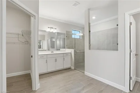 a bathroom with a granite countertop sink mirror and shower