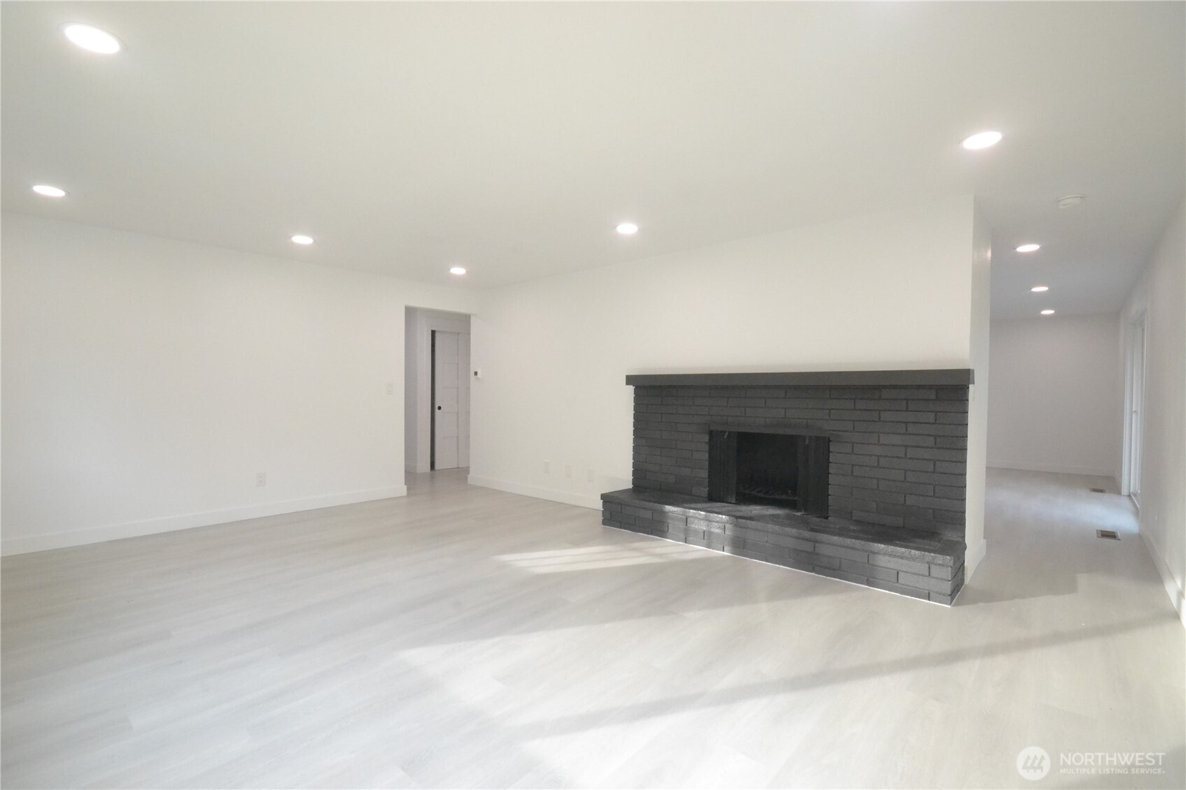 1410 Beech Avenue Steilacoom, WA 98388 - Photo 13 of 38 an empty room with a fireplace and fan