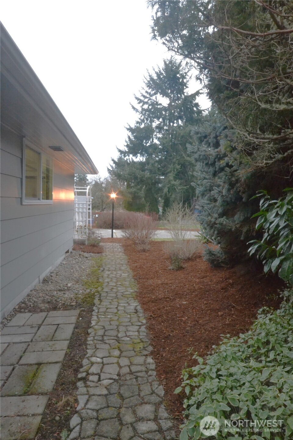 1410 Beech Avenue Steilacoom, WA 98388 - Photo 30 of 38 a view of a yard with plants and a tree