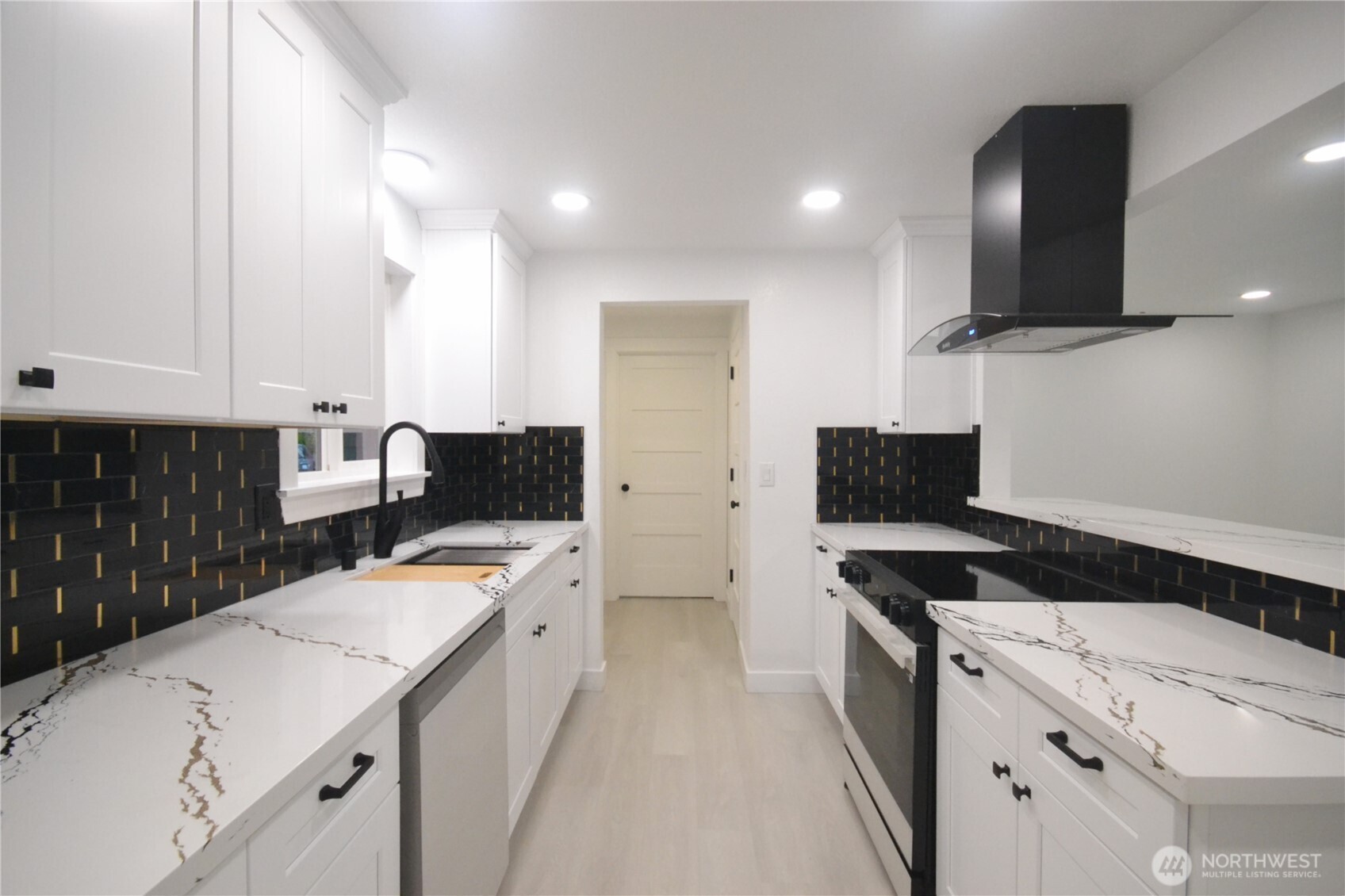 1410 Beech Avenue Steilacoom, WA 98388 - Photo 5 of 38 a kitchen that has a sink and a stove in it