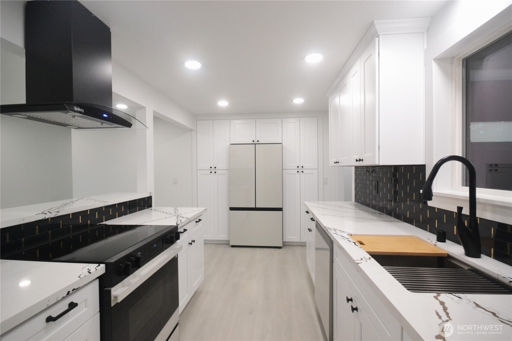 1410 Beech Avenue Steilacoom, WA 98388 - Photo 6 of 38 a kitchen with a sink a stove and refrigerator
