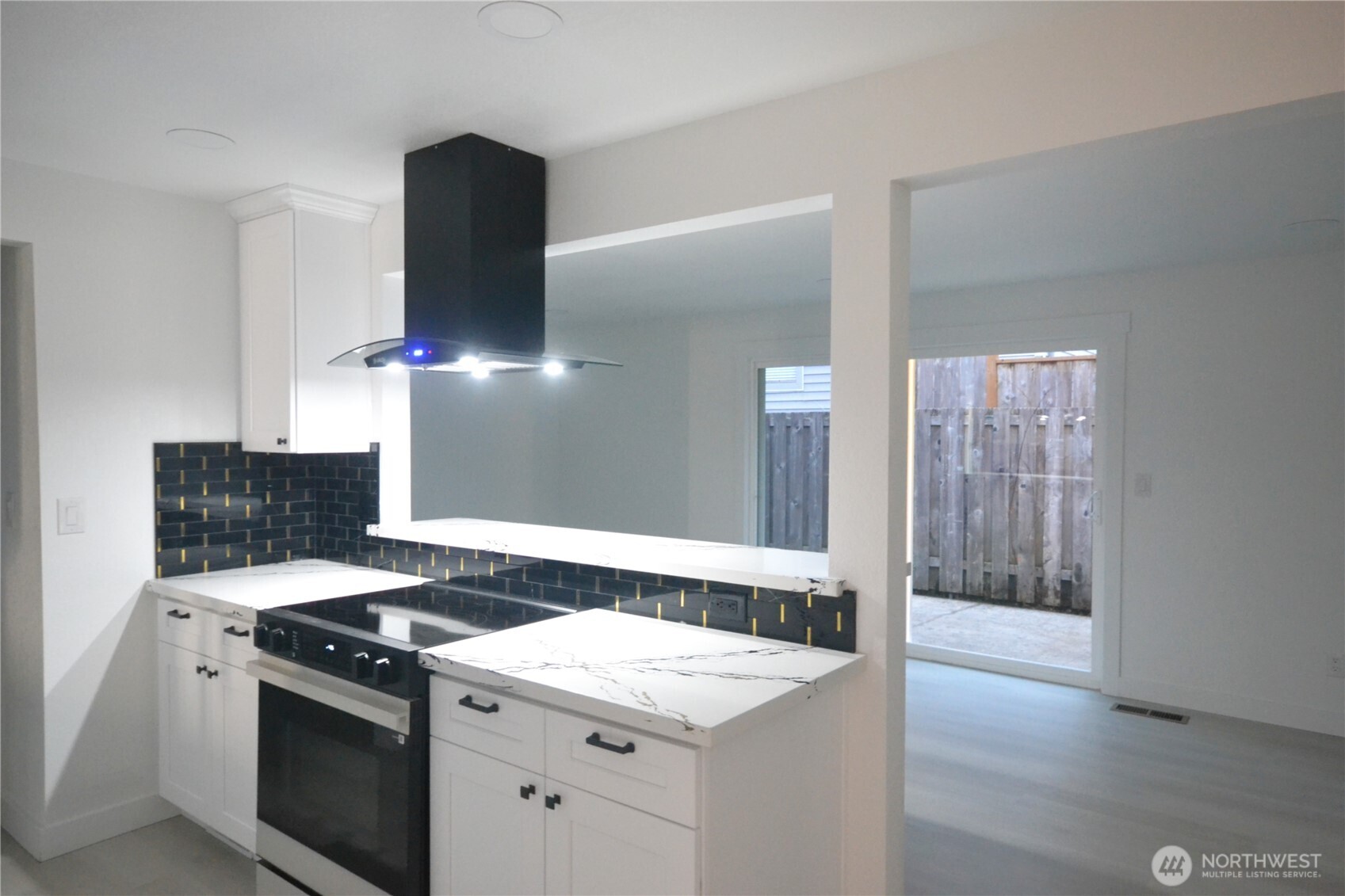 1410 Beech Avenue Steilacoom, WA 98388 - Photo 10 of 38 a kitchen with a stove and a wooden floor