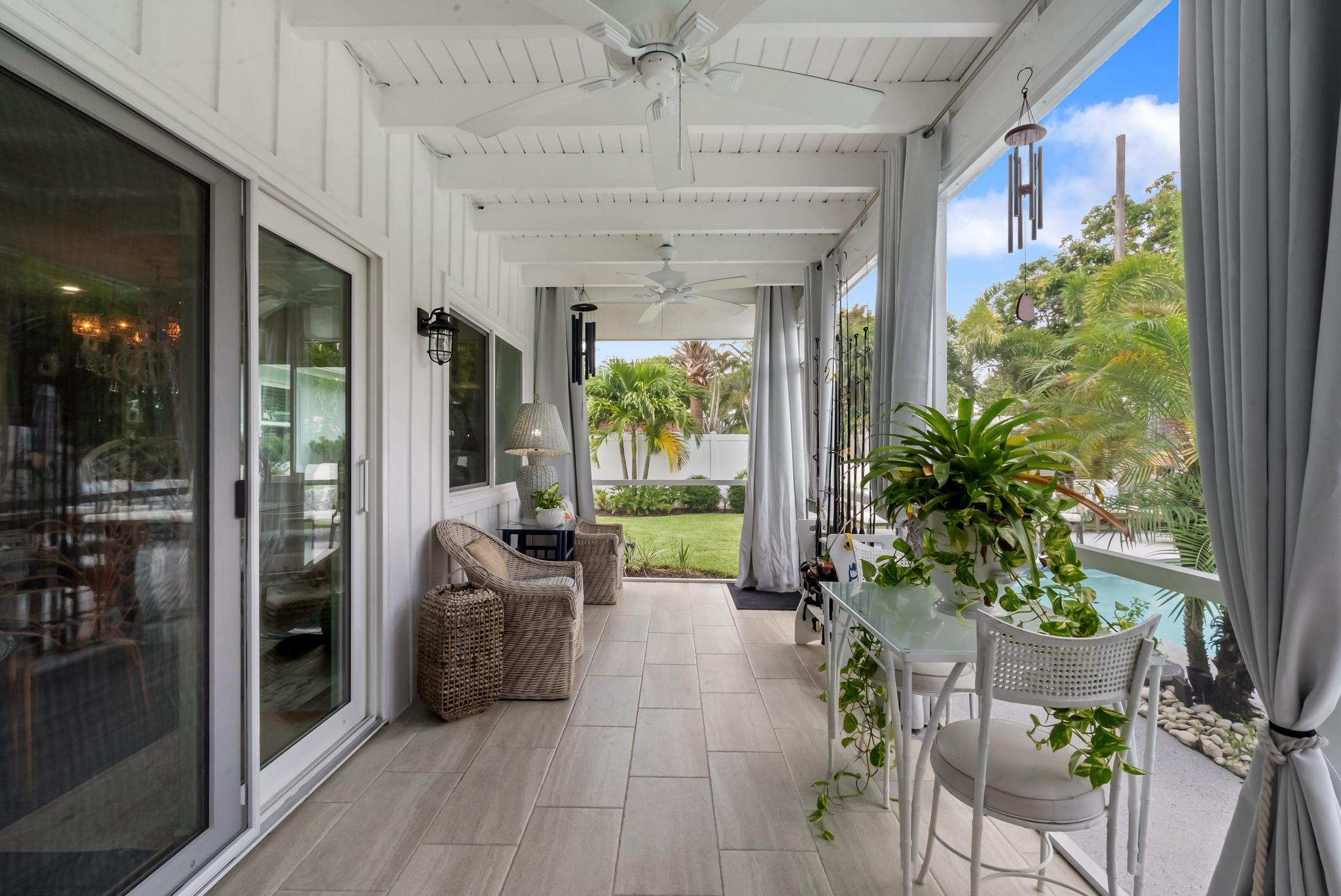 2122 Northridge Road Delray Beach, FL 33444 - Photo 2 of 39 a view of a patio with table and chairs potted plants with wooden floor