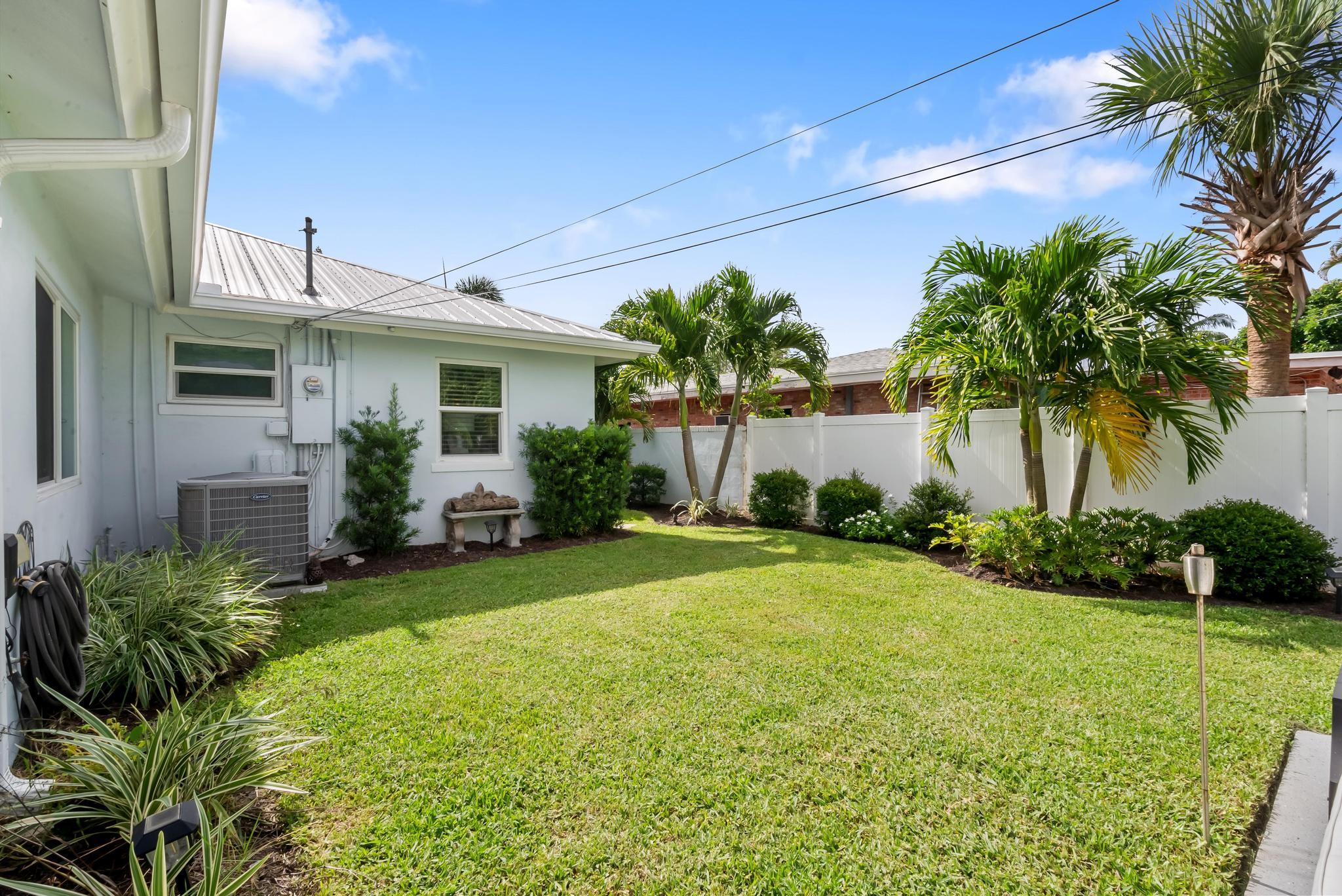 2122 Northridge Road Delray Beach, FL 33444 - Photo 34 of 39 a front view of house with yard and outdoor seating
