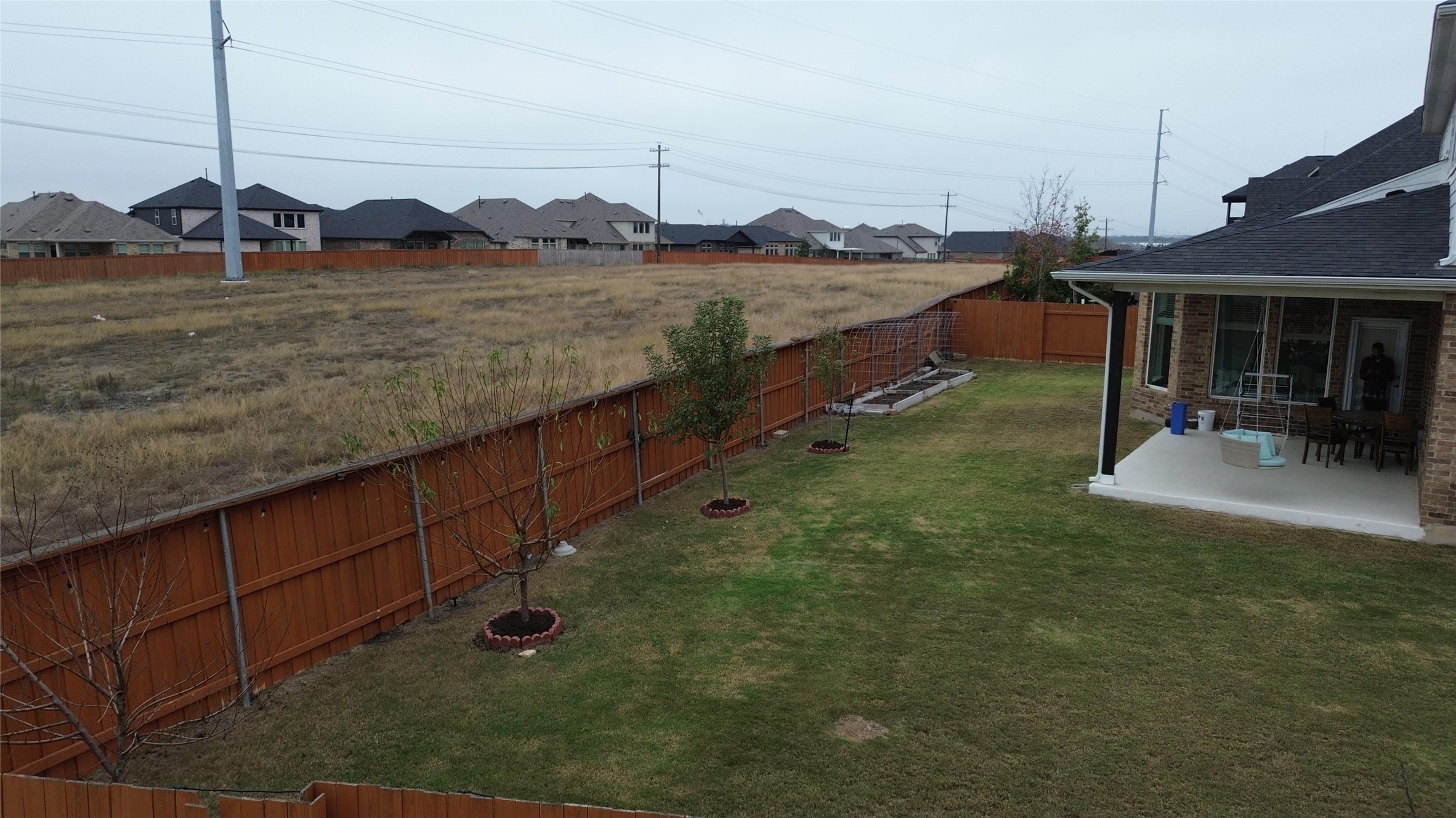 650 Wild Pecan Loop Buda, TX 78610 - Photo 6 of 28 Fenced backyard featuring a residential view and a patio area