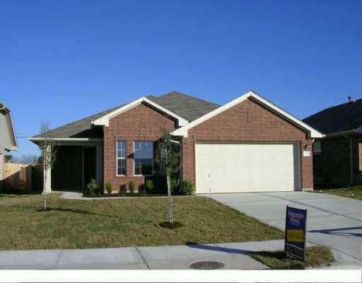 1181 Stone Rim Loop Buda, TX 78610 - Photo 1 of 1 a front view of a house with a yard and garage