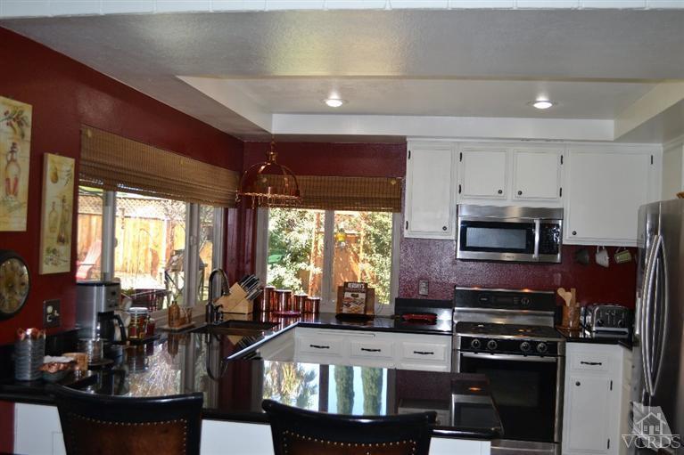 974 Hillview Circle Simi Valley, CA 93065 - Photo 16 of 33 a kitchen with a stove a sink and a refrigerator