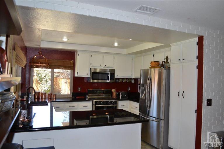 974 Hillview Circle Simi Valley, CA 93065 - Photo 17 of 33 a kitchen with stainless steel appliances granite countertop a refrigerator and a stove top oven
