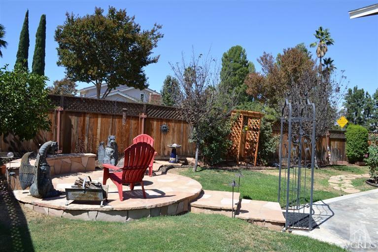 974 Hillview Circle Simi Valley, CA 93065 - Photo 29 of 33 a backyard of a house with table and chairs plants and large tree