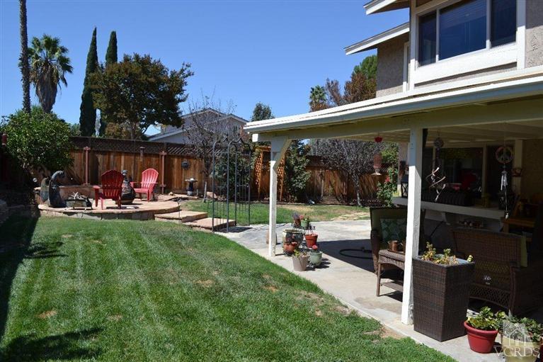 974 Hillview Circle Simi Valley, CA 93065 - Photo 30 of 33 a view of a patio with table and chairs potted plants and palm tree