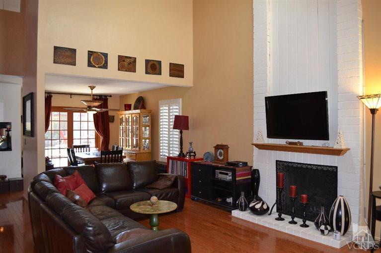 974 Hillview Circle Simi Valley, CA 93065 - Photo 7 of 33 a living room with furniture a flat screen tv and a fireplace