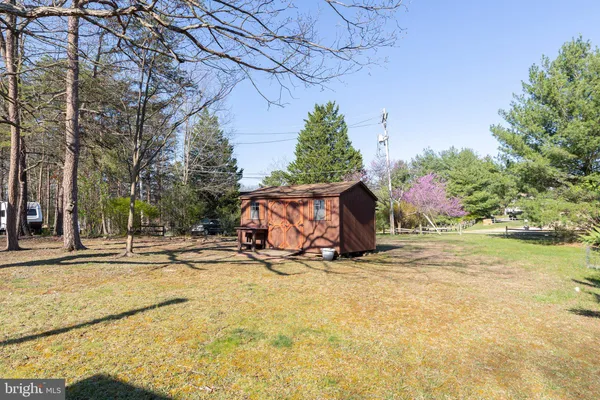 a view of a wooden house with a yard